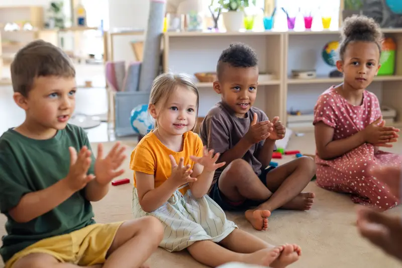 Young children sitting together on the playroom floor at Nursery Rhymes Broughty Ferry