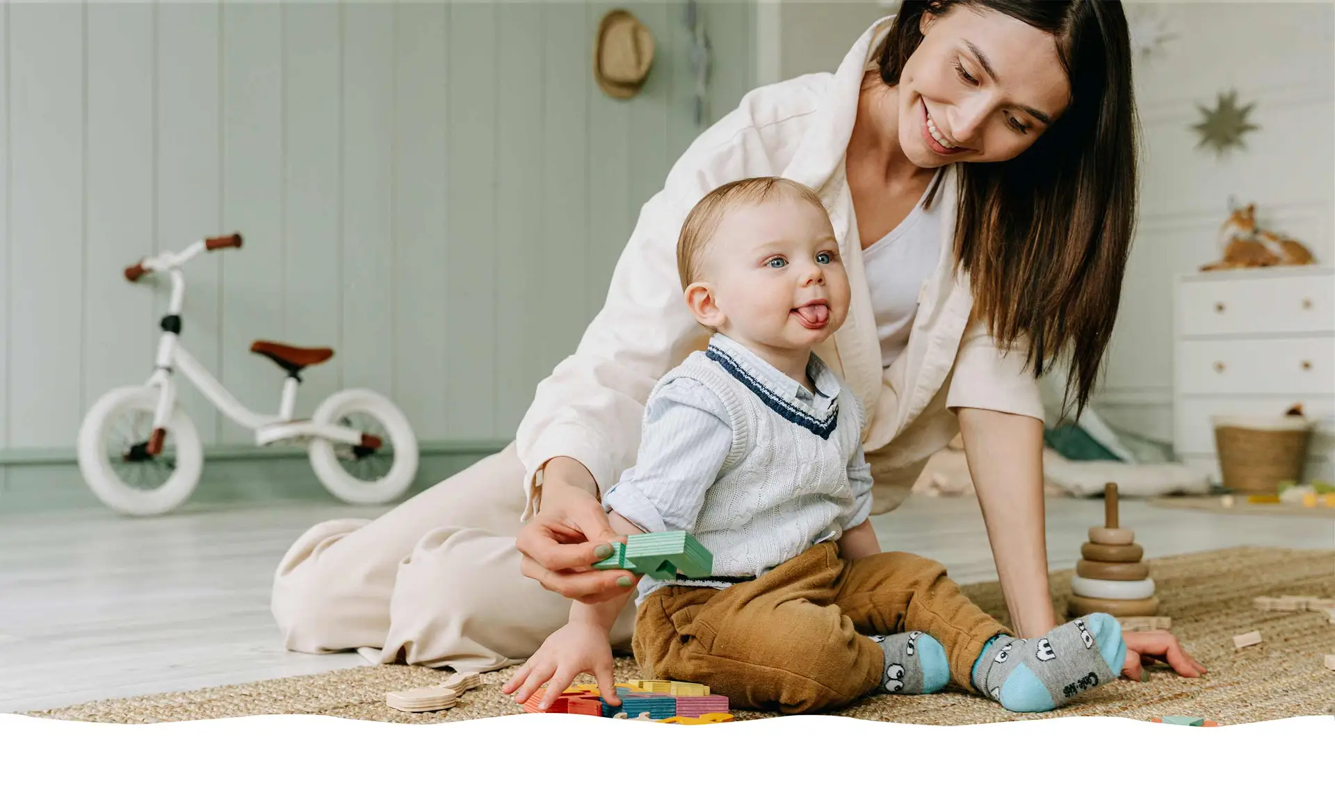 Nursery practitioner playing with a baby on a soft rug Nursery Rhymes Broughty Ferry