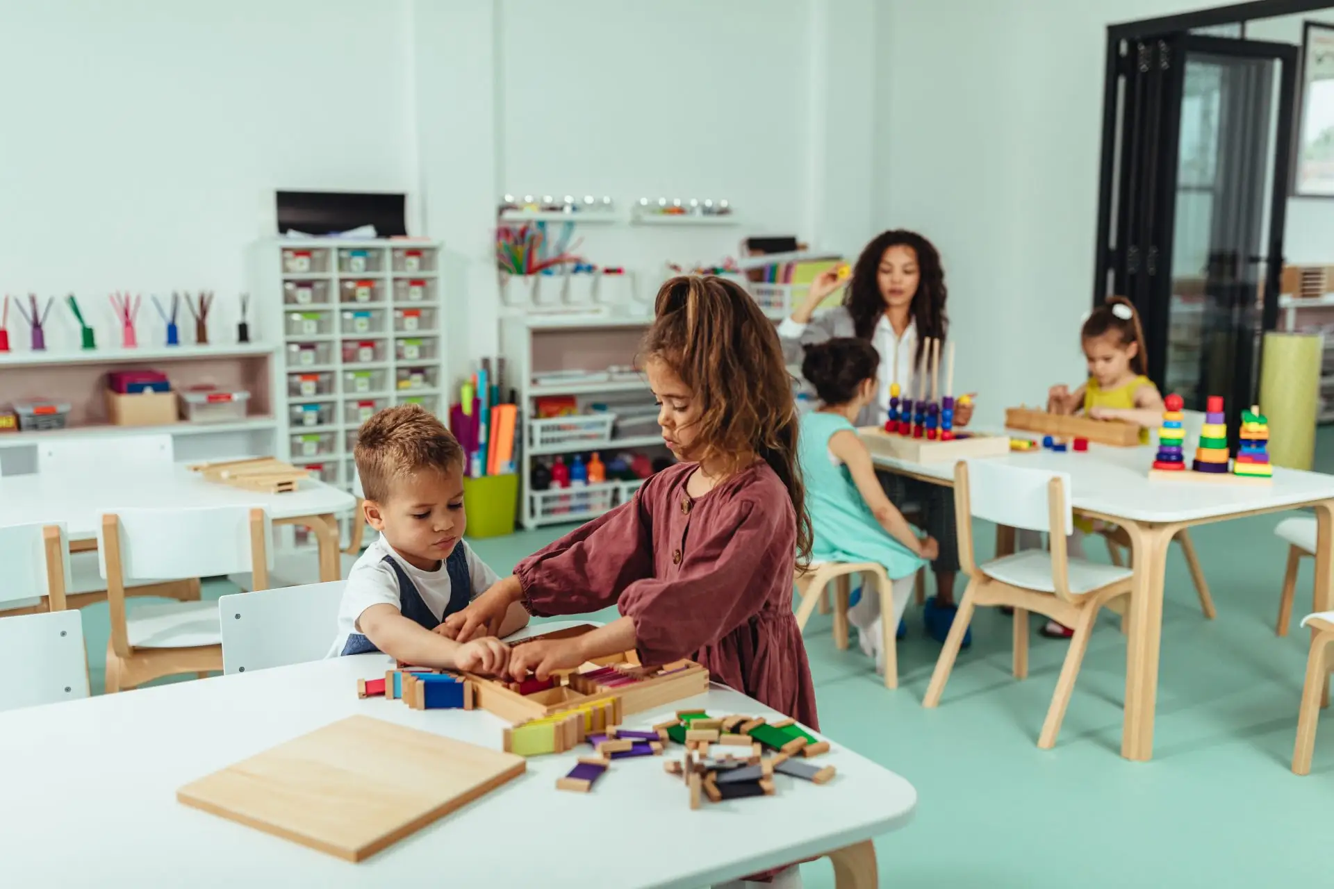 Children playing with wooden toys in a bright nursery classroom Nursery Rhymes Broughty Ferry