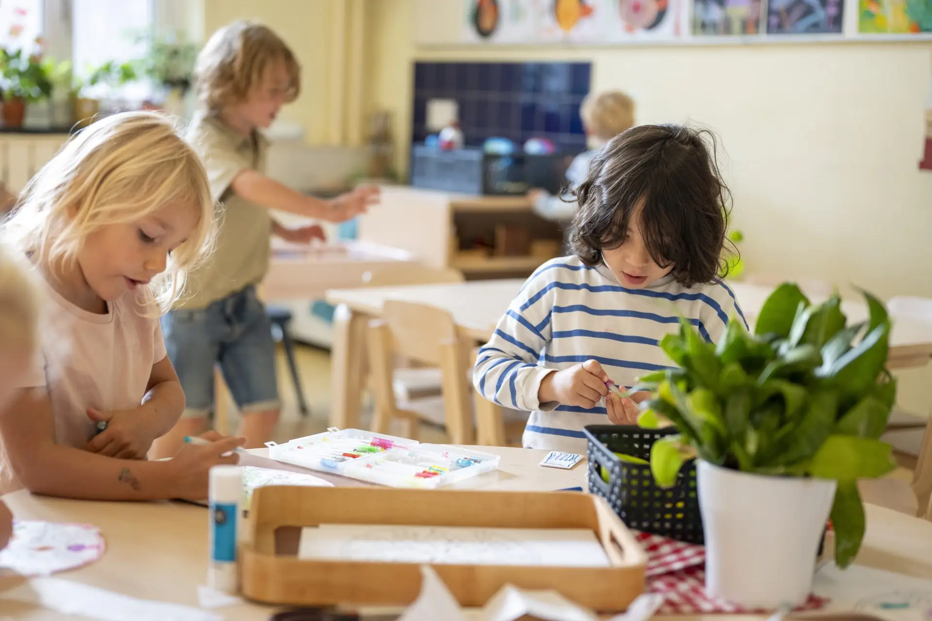 Young children concentrating on learning activities at nursery tables Nursery Rhymes Broughty Ferry